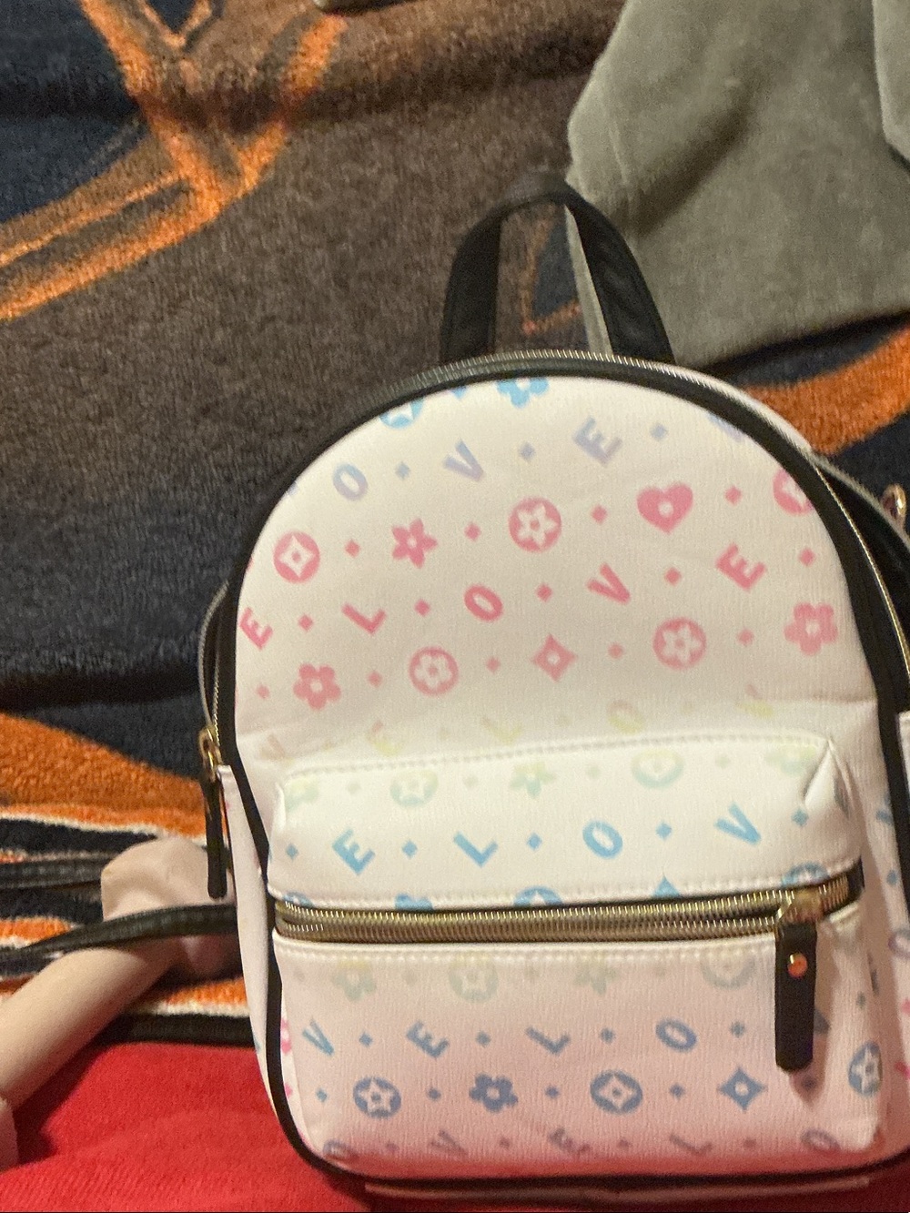 Claire's White Mini Backpack with Pastel Pink, Blue, and Yellow 'LOVE' Print